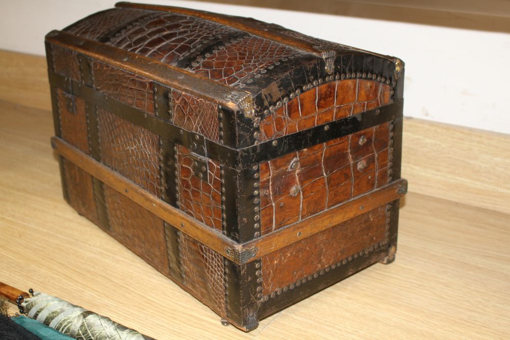 An early 20th century iron and wood bound crocodile covered miniature cabin trunk, with brass latch, length 46cm, height 31.5cm, depth